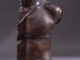 bronze bust of a man with a chain around his neck