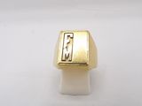 a close up of a gold ring on a white surface