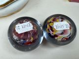 two glass bowls that are sitting on a table