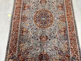 a large persian rug with a medallion design on a white ground