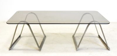 an image of a glass table with metal legs and a glass top