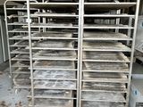 many trays of food that are sitting on a rack