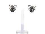 pair of black pearl and diamond earrings on stand