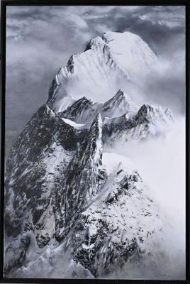 a black and white photo of a snowy mountain