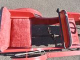 a red sled that is sitting on the ground