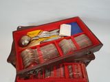 a red case with silverware in it on a white surface