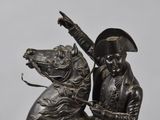 bronze statue of a man on a horse with a sword in his hand