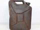 an old brown jerry canister sitting on top of a white table
