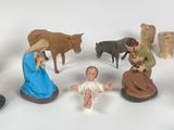 many figurines of people and animals on a white surface