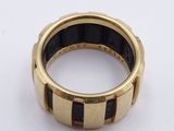 an image of a gold and black ring on a white surface
