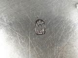 a silver plate with a silver emblem on it