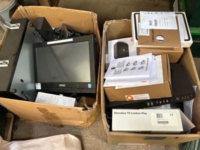 many boxes of electronic equipment sitting on the floor
