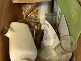 a cardboard box filled with bottles and other items