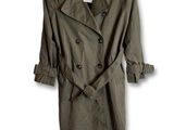 an image of a green trench coat on a hanger on a white wall
