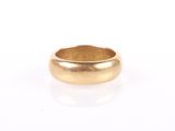 a close up of a gold ring on a white surface
