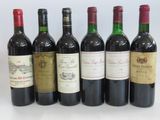 six bottles of wine are lined up in a row on a white surface
