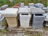 a pile of trash cans sitting on a pallet in the grass