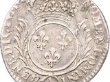 a silver coin with a crown on top of it
