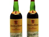 two bottles of wine sitting next to each other on a white surface