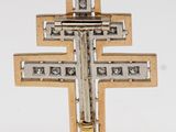 a gold and silver cross on a white background