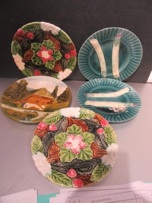 three plates with different designs on them sitting on a table