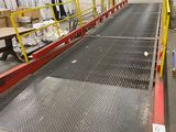 a conveyor belt in the middle of a warehouse