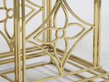a close up of a gold metal table with a glass top
