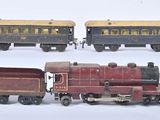 three toy trains sitting next to each other on a white surface