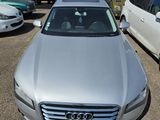 a silver car parked in a parking lot with other cars