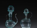 two clear glass vases sitting on top of a table