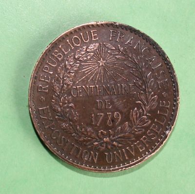 a close up of a coin on a green surface