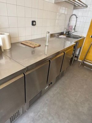 a stainless steel counter top in a kitchen with a sink
