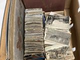 a box full of old photos of people and animals