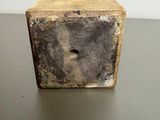 a stone block with a hole in it on a table