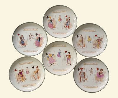 six porcelain plates with pictures of people on them sitting on a table