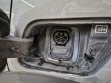 a close up of a car ' s front door with an electric plug attached to it