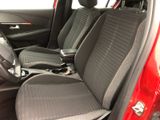 a red car with two black seats in the back of it