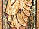 a statue of a man holding a baby in a wooden frame