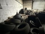 a lot of tires that are stacked up in a room