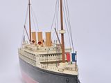 a small model of a ship on a white surface