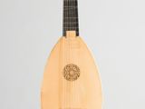 a close up of a small wooden instrument on a white surface