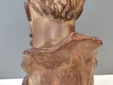 statue of a bust of a man with a beard on a wooden base