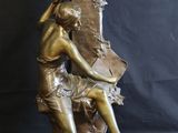 bronze statue of a woman holding a man ' s head