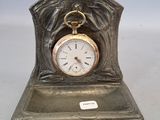 a silver clock that is sitting on top of a table