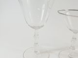 two wine glasses sitting next to each other on a table