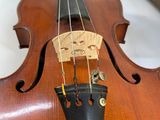 a close up of a violin with a bow on a table