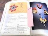 an open book with a bunch of brooches on it