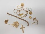 several gold rings, bracelets, rings, and rings on a white surface