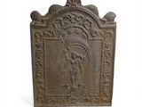 a small cast iron plaque with an image of a man holding a child