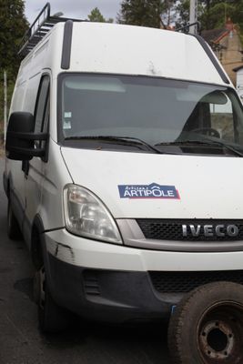 a white van that is parked on the side of the road